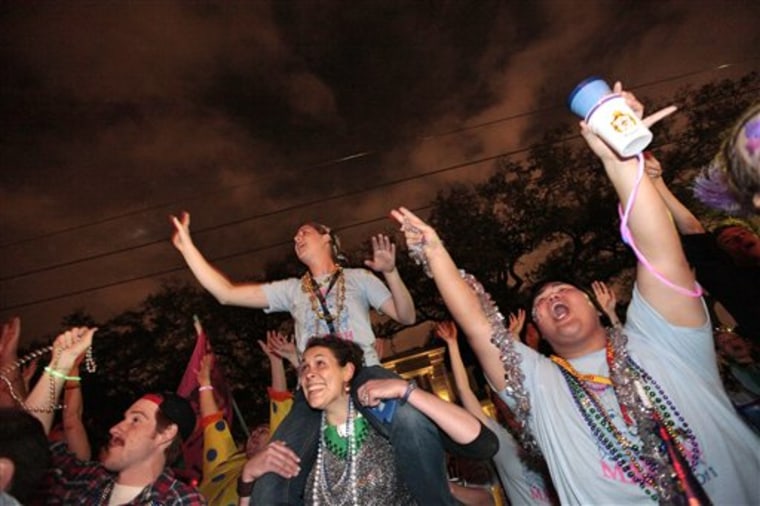 Partiers earlier this week raised their hands for beads and trinkets during the Krewe of Chaos Mardi Gras parade on St. Charles Avenue in New Orleans. The city expects its largest crowd for the annual celebration since Hurricane Katrina struck in 2005. 